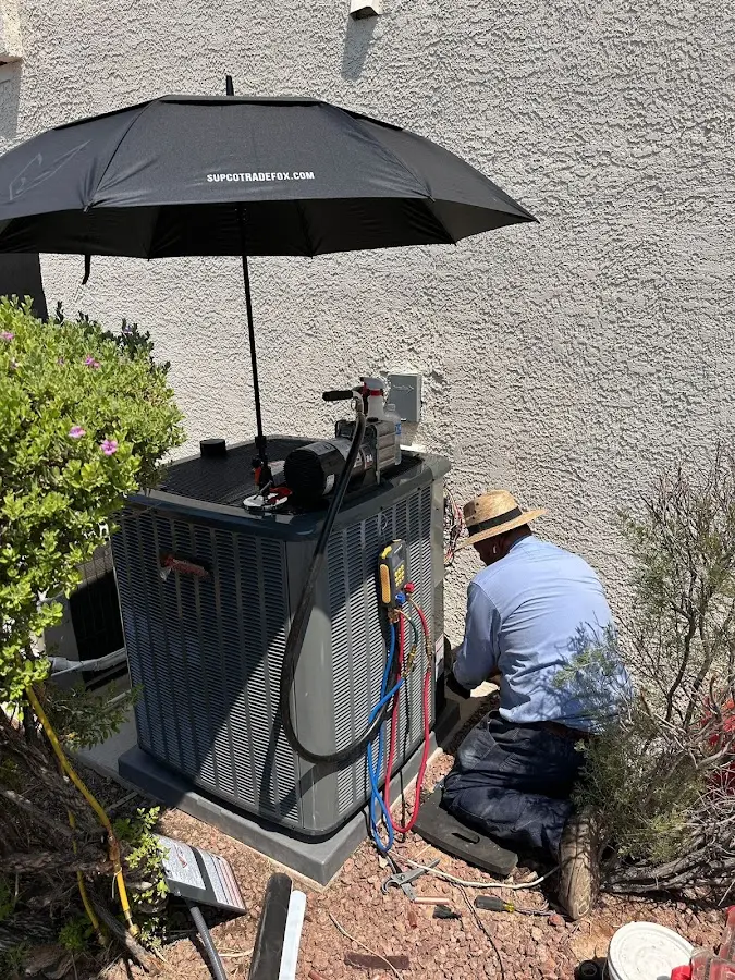 HVAC technician performing outdoor AC maintenance in Cherry Hill